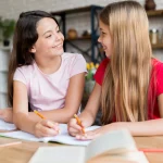 schoolgirls doing homework looking each other 1024x1024