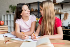 schoolgirls doing homework looking each other 1024x1024